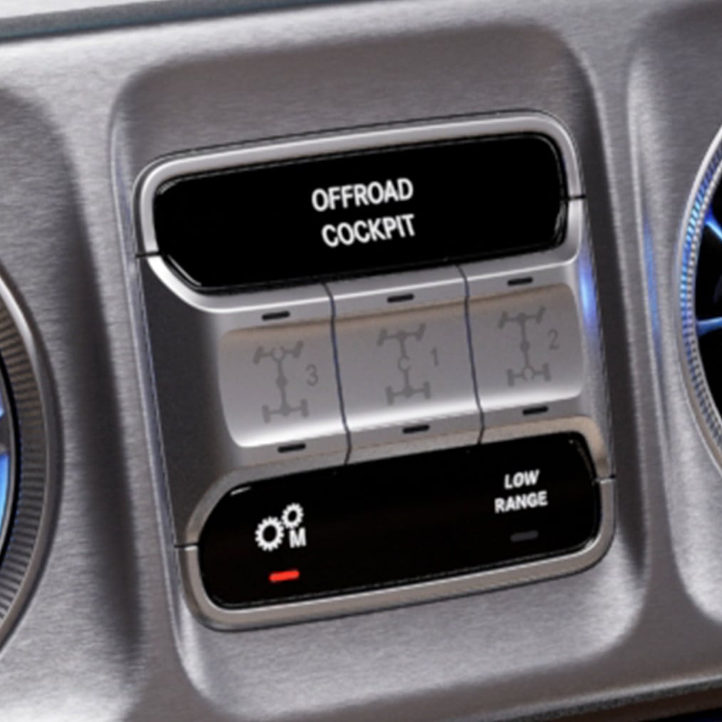 Close-up van het OFFROAD-cockpit van een G-Klasse met de drie schakelaars voor de differentieelsperren.