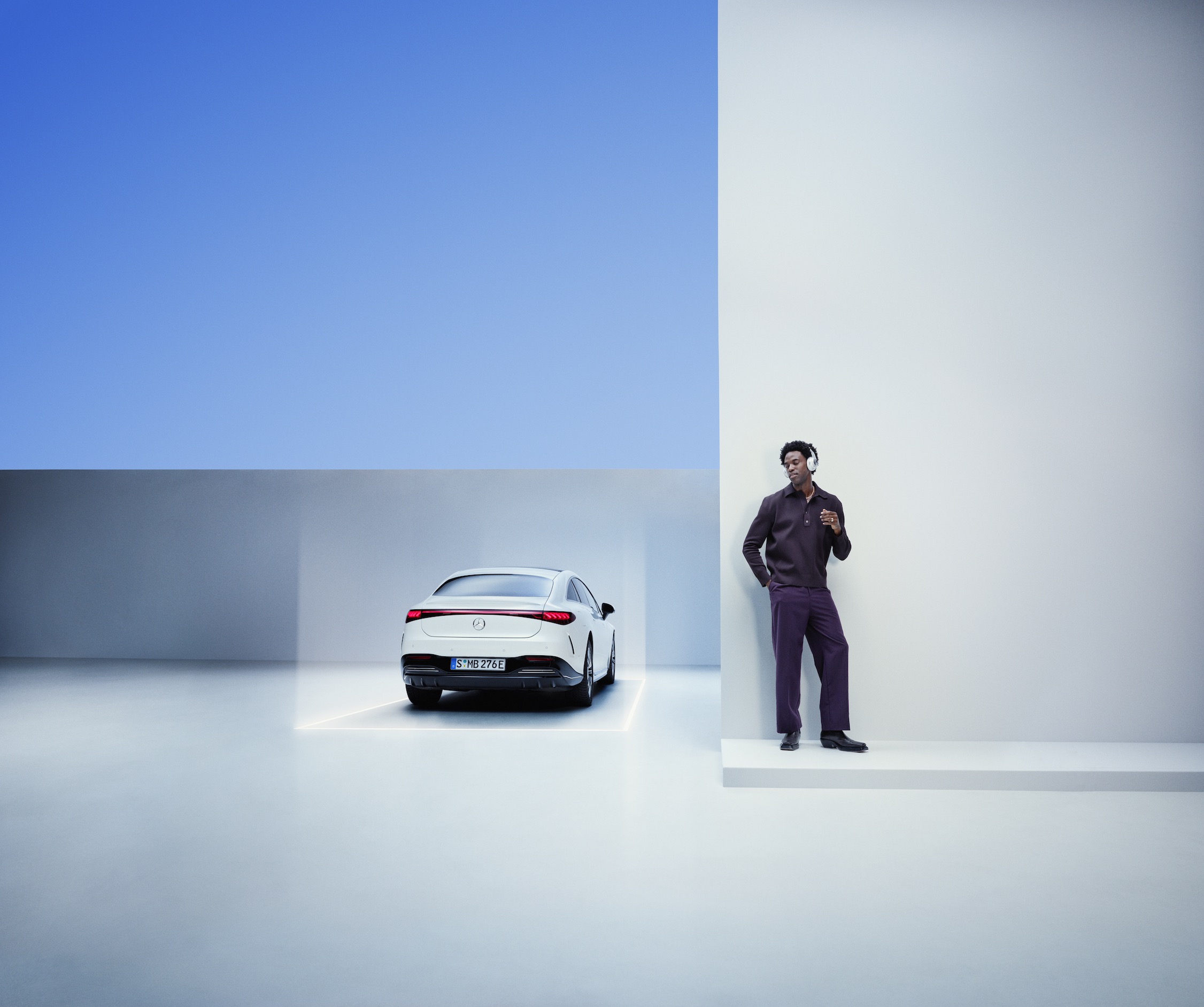 Mercedes-Benz ServiceCare Un homme s'appuie contre un mur à côté d'une Mercedes-Benz.