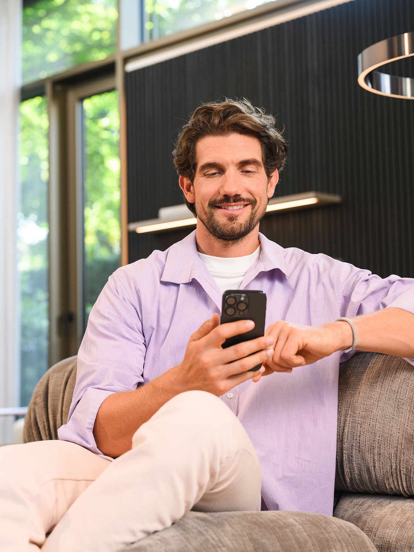 Une personne assise utilisant un appareil mobile.​