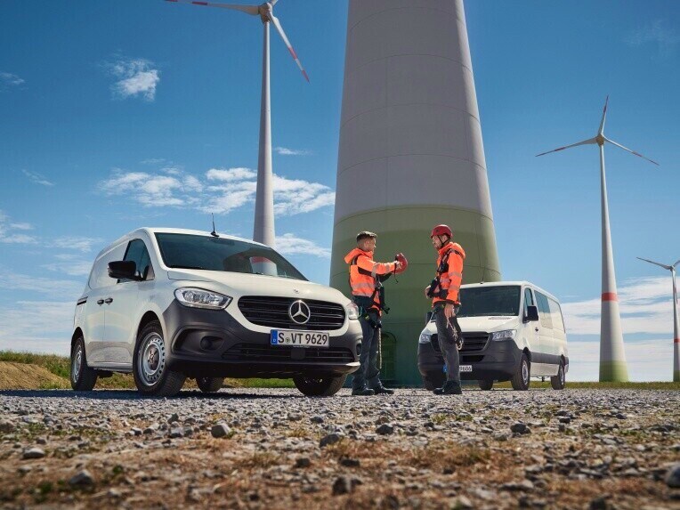 Twee Mercedes-Benz bestelwagens op een bouwplaats.
