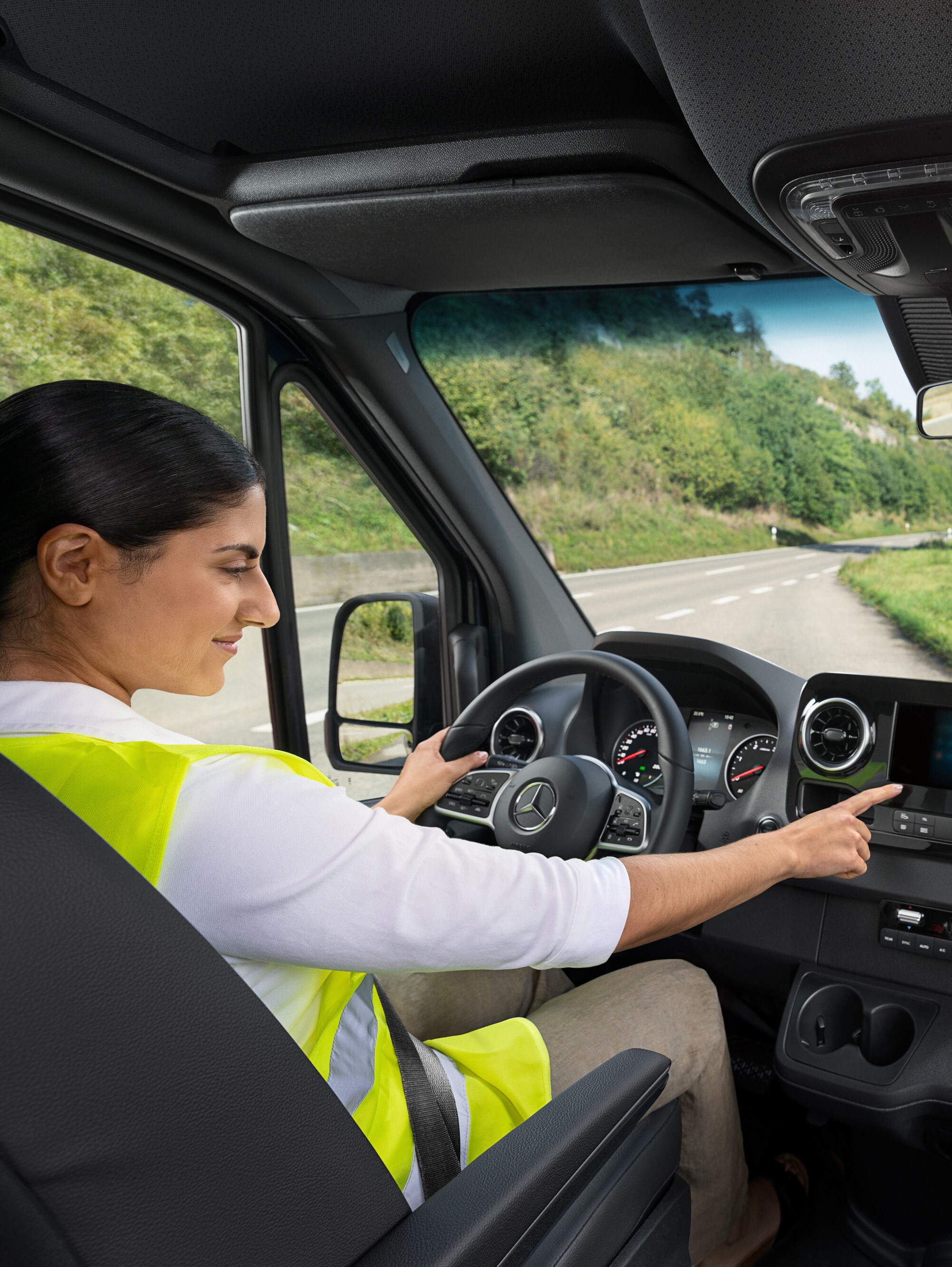 Chauffeur controleert het display in haar Mercedes-Benz bestelwagen.